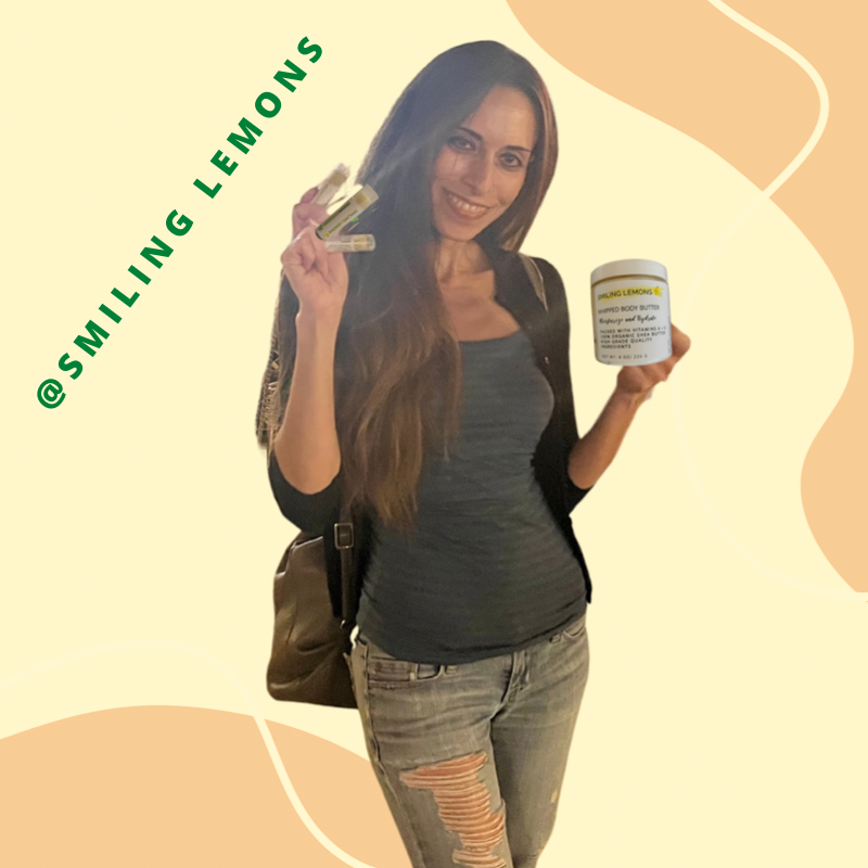 Smiling Female holding lip balms and body butter 